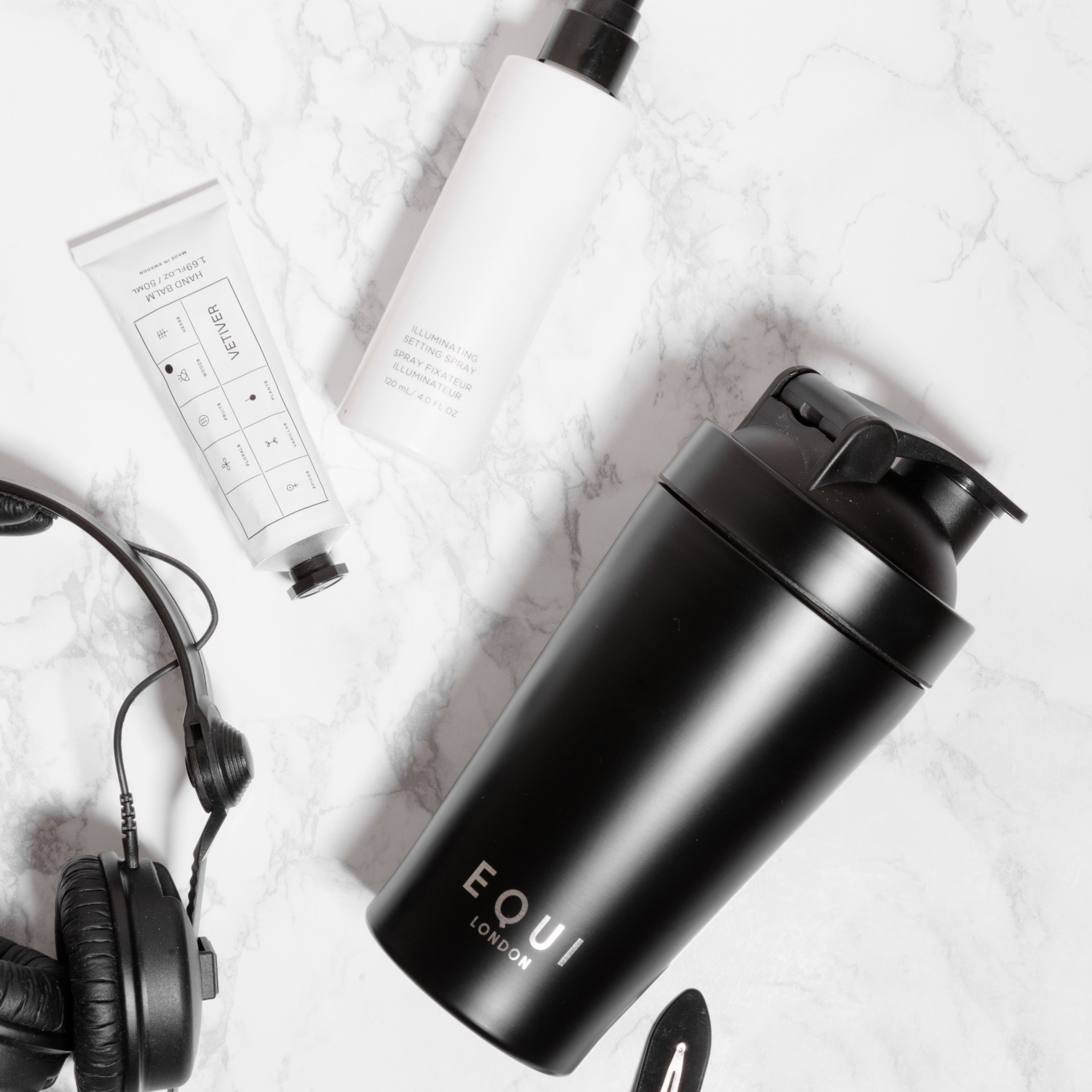  Equi Shaker with headphones and cosmetics on a marble background