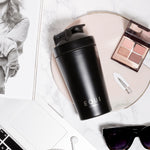  Equi Shaker with eyeshadow and a laptop on a marble background